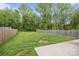 A large, grassy backyard surrounded by a wooden fence, perfect for outdoor activities at 2821 Shamrock Dr, Charlotte, NC 28205