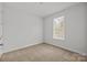 Bright bedroom with neutral carpet and a window at 2821 Shamrock Dr, Charlotte, NC 28205