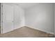 Bedroom offers neutral carpet and two doors at 2821 Shamrock Dr, Charlotte, NC 28205
