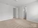 Bright bedroom with carpeted floor and multiple closets for ample storage at 2821 Shamrock Dr, Charlotte, NC 28205