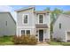 Charming two-story home featuring a gray siding, stylish windows, and a well-manicured front yard at 2821 Shamrock Dr, Charlotte, NC 28205