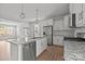 Bright kitchen featuring stainless appliances, granite countertops, white cabinets and an island with seating at 2821 Shamrock Dr, Charlotte, NC 28205
