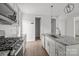 Bright kitchen featuring stainless appliances, granite countertops, and tile backsplash at 2821 Shamrock Dr, Charlotte, NC 28205