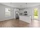 Bright kitchen features stainless appliances, granite countertops, white cabinets and an island at 2821 Shamrock Dr, Charlotte, NC 28205