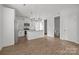 Bright, open kitchen featuring white cabinets, stainless steel appliances, and a granite countertop island at 2821 Shamrock Dr, Charlotte, NC 28205