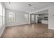 Open-concept living space with wood floors, a view of the kitchen, and plenty of natural light at 2821 Shamrock Dr, Charlotte, NC 28205