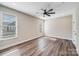 Bright bedroom boasts hardwood floors, shiplap accent wall, and natural light from two windows at 28655-A Nc Hwy 73 Hwy, Albemarle, NC 28001