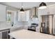 Modern kitchen with white cabinets, stainless steel appliances, subway tile backsplash, and a farmhouse sink at 28655-A Nc Hwy 73 Hwy, Albemarle, NC 28001