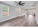 Bright living room with wood floors, a ceiling fan, and views of the outdoors at 28655-A Nc Hwy 73 Hwy, Albemarle, NC 28001