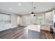 Bright and airy living space with a kitchen island, wood floors, and neutral paint colors at 28655-A Nc Hwy 73 Hwy, Albemarle, NC 28001