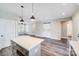 Open concept living area showcasing the kitchen island, wood flooring, and modern finishes at 28655-A Nc Hwy 73 Hwy, Albemarle, NC 28001