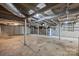 Unfinished basement featuring exposed ductwork, painted brick walls, and concrete flooring at 330 Clover St, Mooresville, NC 28115
