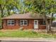 Charming brick home featuring a well-maintained lawn, mature trees, and a welcoming front entrance at 330 Clover St, Mooresville, NC 28115