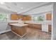 Well-lit kitchen featuring wood cabinets, light countertops, and modern appliances at 330 Clover St, Mooresville, NC 28115