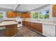 Traditional-style kitchen with wood cabinets, white appliances, and a window overlooking the backyard at 330 Clover St, Mooresville, NC 28115