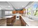 Bright kitchen featuring wood cabinets, laminate countertops, a range, a large sink, and ample natural light at 330 Clover St, Mooresville, NC 28115