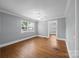 Inviting living room with hardwood floors, a ceiling fan, and plenty of natural light at 330 Clover St, Mooresville, NC 28115