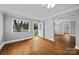 Bright living room with hardwood floors, fresh paint, and natural light from the window at 330 Clover St, Mooresville, NC 28115