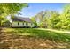 Spacious backyard with lush lawn, mature trees, a deck, and garden, ideal for outdoor entertaining and relaxation at 3509 Seminole Dr, Maiden, NC 28650