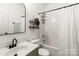 Bright bathroom with updated vanity, mirror, and fixtures alongside a tub with shower at 3509 Seminole Dr, Maiden, NC 28650