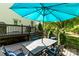 Outdoor dining on the deck under a large umbrella with blue cushioned chairs, perfect for entertaining at 3509 Seminole Dr, Maiden, NC 28650