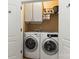 Laundry room featuring a front-load washer and dryer and overhead cabinets at 3509 Seminole Dr, Maiden, NC 28650