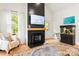 Cozy living room with a fireplace, mounted TV, and a comfortable armchair by the window at 3509 Seminole Dr, Maiden, NC 28650