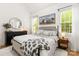 Bedroom with hardwood floors, windows with bright light and a black dresser at 3509 Seminole Dr, Maiden, NC 28650