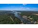 Aerial view of a lakefront property at 378 Shoreline Drive surrounded by lush greenery at 378 Shoreline Dr, New London, NC 28127