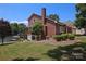 Brick home featuring a view of the lake and boathouse from the backyard at 378 Shoreline Dr, New London, NC 28127