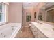 Bathroom featuring a soaking tub, double vanity, and large mirror at 378 Shoreline Dr, New London, NC 28127