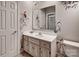 Well-lit bathroom with a white vanity and decorative floral wallpaper accents at 378 Shoreline Dr, New London, NC 28127