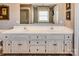 Bathroom with double sinks, granite countertop, and white cabinets for a clean and elegant look at 378 Shoreline Dr, New London, NC 28127