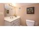 Compact bathroom featuring a vanity with a sink, toilet, and neutral wall color at 378 Shoreline Dr, New London, NC 28127
