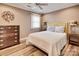 Cozy bedroom with wood floors, queen bed, dresser, and bedside lamps, bright window at 378 Shoreline Dr, New London, NC 28127