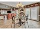 Dining area with glass table, unique chairs, and view into the living room featuring leather seating at 378 Shoreline Dr, New London, NC 28127