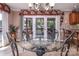 Elegant dining area with a glass table, stylish chairs, and picturesque views of the lake at 378 Shoreline Dr, New London, NC 28127
