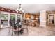 Charming dining area with a glass table and chairs, adjacent to the kitchen and offering water views at 378 Shoreline Dr, New London, NC 28127