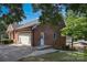 Brick home with a two-car garage and an adjacent side entrance at 378 Shoreline Dr, New London, NC 28127