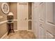 Hallway featuring white doors, neutral wall color and tiled floor, creating a clean and inviting space at 378 Shoreline Dr, New London, NC 28127