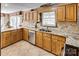 Bright kitchen with granite countertops, stainless steel appliances, and custom wooden cabinets at 378 Shoreline Dr, New London, NC 28127