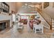 Inviting living room featuring a brick fireplace, staircase, and comfortable leather sofas at 378 Shoreline Dr, New London, NC 28127