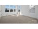 Bright and airy bedroom featuring neutral carpet, white walls, and large windows for natural light at 433 Blairhill Rd # 08, Charlotte, NC 28217