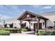 Building's main entrance with wood frame, hanging lights, landscaping, and manicured bushes at 433 Blairhill Rd # 08, Charlotte, NC 28217