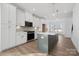 Bright, contemporary kitchen featuring white cabinets, stainless appliances, a large island, and modern pendant lighting at 433 Blairhill Rd # 08, Charlotte, NC 28217