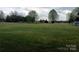 Expansive back yard with mature trees, shed, and ample space at 4330 Goodman Lake Rd, Salisbury, NC 28146