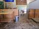 Spacious barn interior featuring stalls and a metal gate, offering ample space for livestock at 4330 Goodman Lake Rd, Salisbury, NC 28146