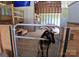 Interior barn view with animal gate and wooden structures, providing a functional layout for animals at 4330 Goodman Lake Rd, Salisbury, NC 28146
