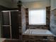 Bathroom featuring a walk-in shower and large bathtub at 4330 Goodman Lake Rd, Salisbury, NC 28146
