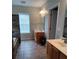 Bathroom featuring stone accent wall, shower, jacuzzi tub, and double vanities with ample counter space at 4330 Goodman Lake Rd, Salisbury, NC 28146